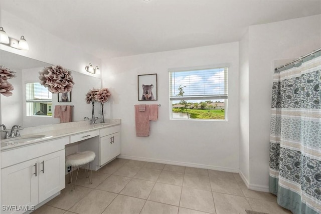 8959 Cascade Price Cir, North Fort Myers, FL 33917 - bathroom featuring plenty of natural light, double vanity, tile patterned flooring, and a shower with shower curtain