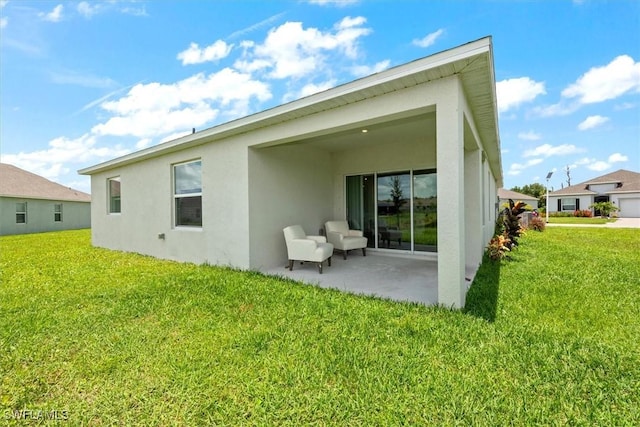 8959 Cascade Price Cir, North Fort Myers, FL 33917 - rear view of house featuring stucco siding, a patio, and a yard
