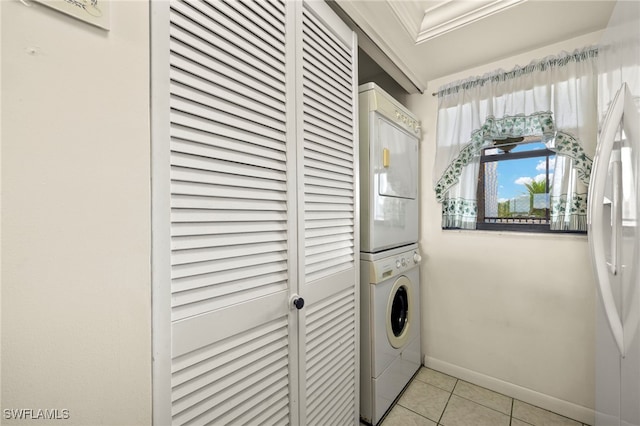 1901 Clifford St Unit 202, Fort Myers, FL 33901 - washroom with estacked washer and dryer and light tile patterned floors