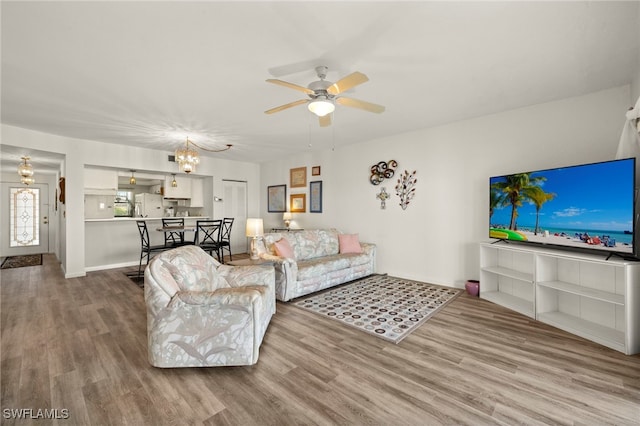 1901 Clifford St Unit 202, Fort Myers, FL 33901 - living area with wood finished floors, a ceiling fan, and a chandelier