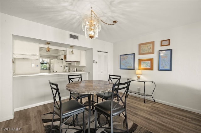 1901 Clifford St Unit 202, Fort Myers, FL 33901 - dining area with a chandelier and dark wood finished floors