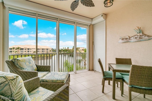9190 Southmont Cv Unit 306, Fort Myers, FL 33908 - sunroom with a water view, tile patterned flooring, and a textured wall