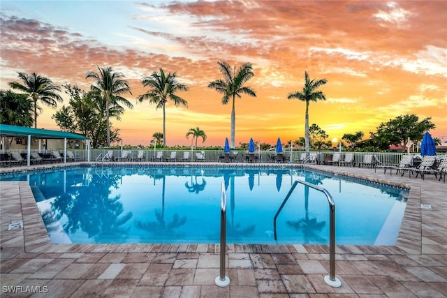 9190 Southmont Cv Unit 306, Fort Myers, FL 33908 - pool at dusk featuring a community pool and a patio