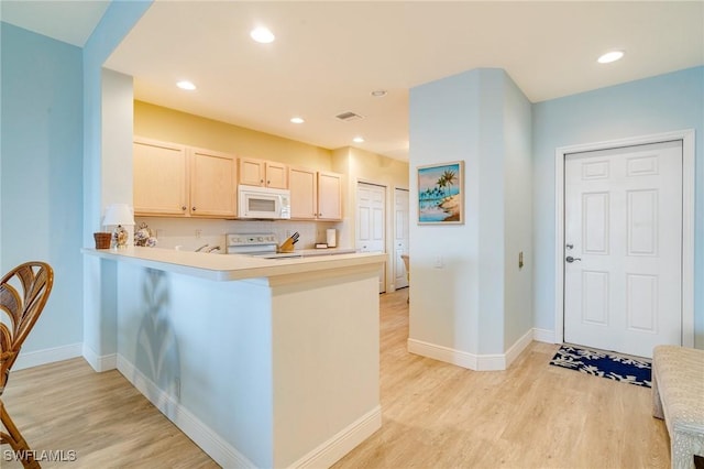9190 Southmont Cv Unit 306, Fort Myers, FL 33908 - kitchen featuring light wood-style floors, light countertops, white microwave, range with electric cooktop, and recessed lighting