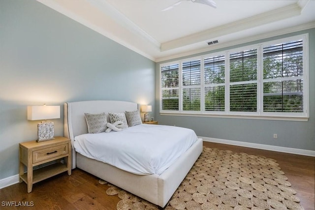 29120 Brendisi Way Unit 102, Naples, FL 34110 - bedroom featuring ornamental molding, a tray ceiling, and wood finished floors