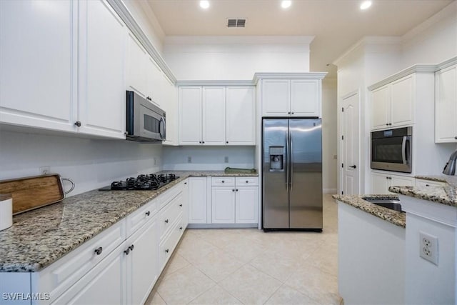 29120 Brendisi Way Unit 102, Naples, FL 34110 - kitchen with stainless steel appliances, white cabinets, light stone counters, crown molding, and recessed lighting