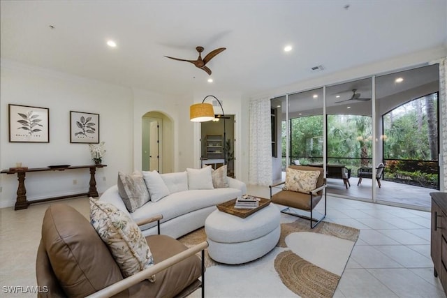 29120 Brendisi Way Unit 102, Naples, FL 34110 - living room featuring ceiling fan, expansive windows, recessed lighting, arched walkways, and light tile patterned floors
