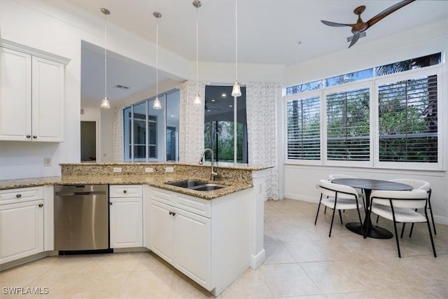 29120 Brendisi Way Unit 102, Naples, FL 34110 - kitchen with stainless steel dishwasher, light tile patterned floors, white cabinetry, and decorative light fixtures