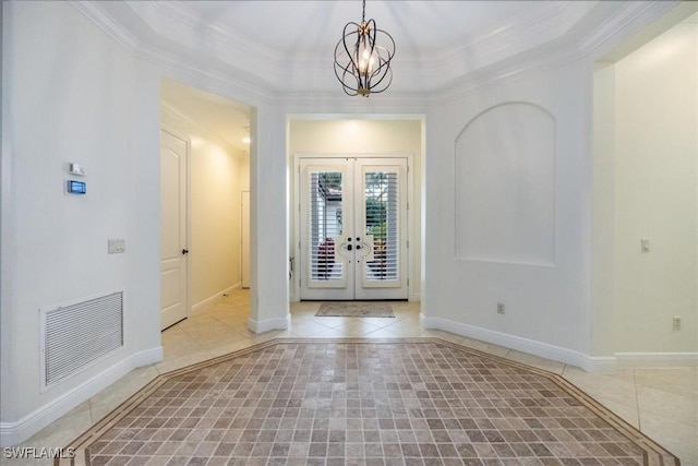 29120 Brendisi Way Unit 102, Naples, FL 34110 - tiled foyer featuring crown molding, a chandelier, french doors, inlaid floor details, and a tray ceiling
