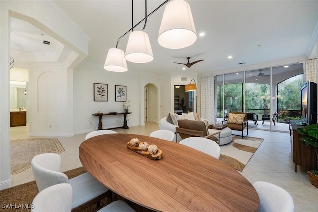 29120 Brendisi Way Unit 102, Naples, FL 34110 - dining space with arched walkways, ceiling fan, ornamental molding, light tile patterned floors, and recessed lighting