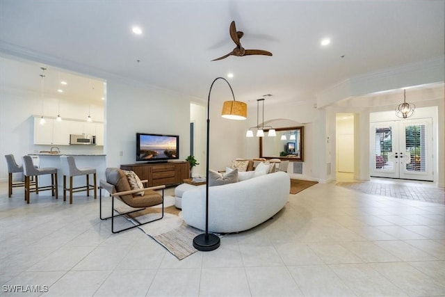 29120 Brendisi Way Unit 102, Naples, FL 34110 - living area featuring crown molding, light tile patterned flooring, a ceiling fan, french doors, and recessed lighting