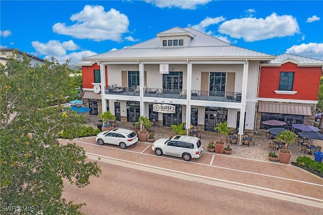 15898 Sugar Hill Dr, Punta Gorda, FL 33982 - multi unit property featuring a metal roof, stone siding, and a balcony