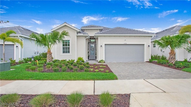 15898 Sugar Hill Dr, Punta Gorda, FL 33982 - view of front facade featuring decorative driveway and a garage