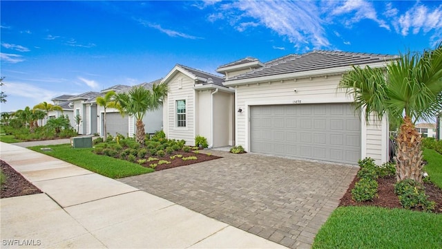 15898 Sugar Hill Dr, Punta Gorda, FL 33982 - view of front facade featuring a garage, driveway, and a tile roof