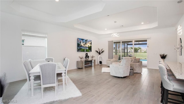 15898 Sugar Hill Dr, Punta Gorda, FL 33982 - dining area featuring a raised ceiling, light wood finished floors, and recessed lighting