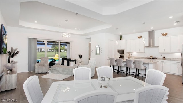 15898 Sugar Hill Dr, Punta Gorda, FL 33982 - dining room with a tray ceiling, dark wood finished floors, and recessed lighting