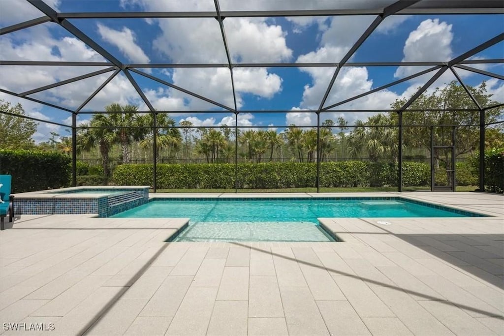 8939 Redonda Dr, Naples, FL 34114 - view of swimming pool featuring a patio, a pool with connected hot tub, and glass enclosure