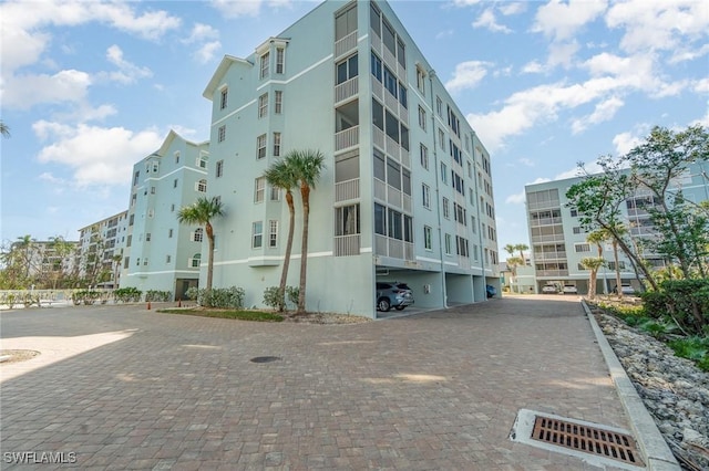 22724 Island Pines Way Unit 101, Fort Myers Beach, FL 33931 - view of property featuring covered parking