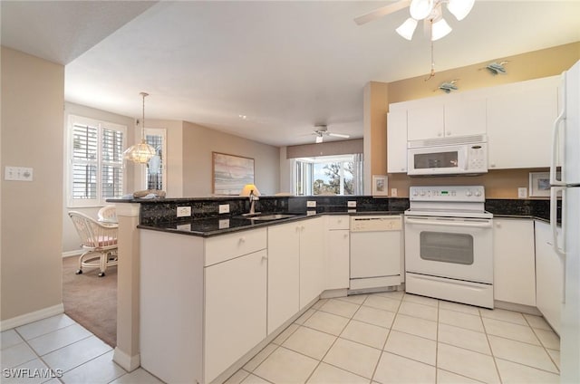 22724 Island Pines Way Unit 101, Fort Myers Beach, FL 33931 - kitchen featuring ceiling fan, white appliances, a peninsula, white cabinetry, and decorative light fixtures