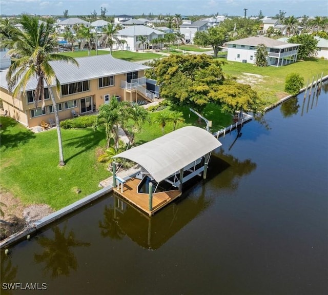 24398 Treasure Island Blvd, Punta Gorda, FL 33955 - dock area with a water view, a yard, boat lift, and a residential view