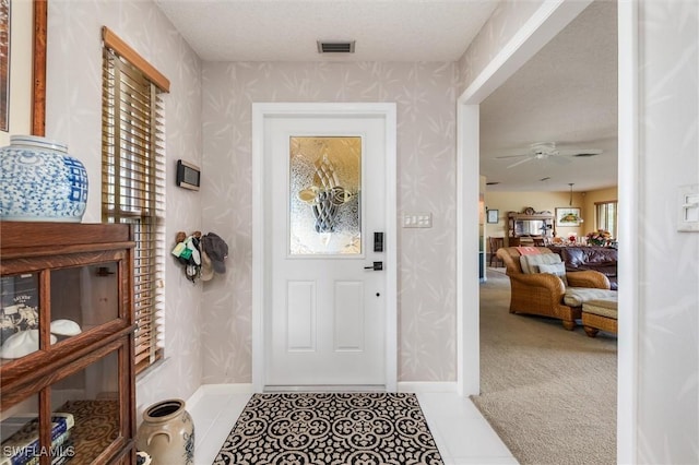 24398 Treasure Island Blvd, Punta Gorda, FL 33955 - foyer with wallpapered walls and a ceiling fan
