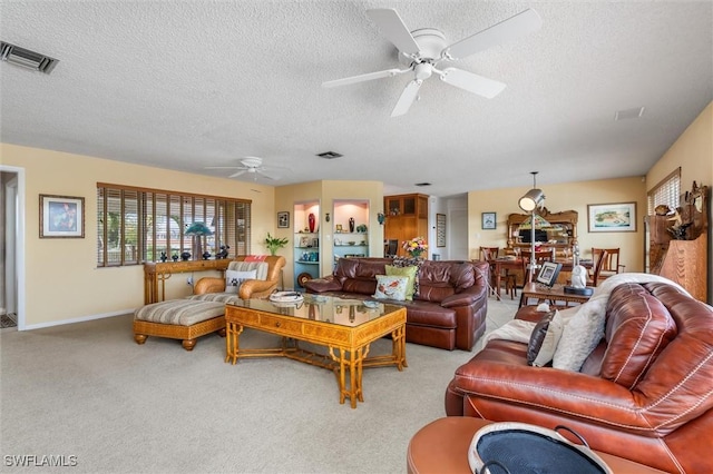 24398 Treasure Island Blvd, Punta Gorda, FL 33955 - living area featuring a ceiling fan, a textured ceiling, and carpet
