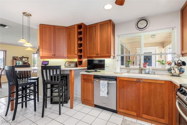24398 Treasure Island Blvd, Punta Gorda, FL 33955 - kitchen featuring appliances with stainless steel finishes, light countertops, brown cabinetry, and recessed lighting