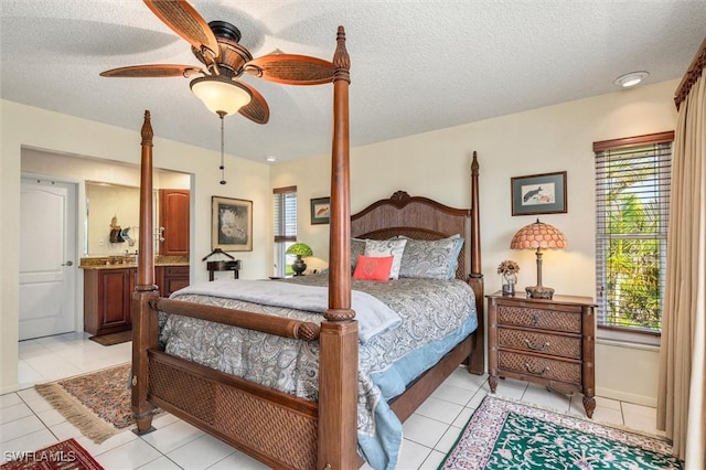 24398 Treasure Island Blvd, Punta Gorda, FL 33955 - bedroom featuring light tile patterned flooring, a textured ceiling, ensuite bathroom, and a ceiling fan