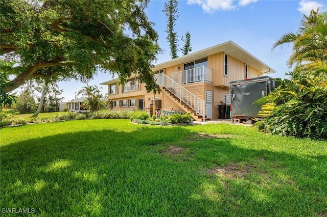 24398 Treasure Island Blvd, Punta Gorda, FL 33955 - rear view of property with stairway and a yard