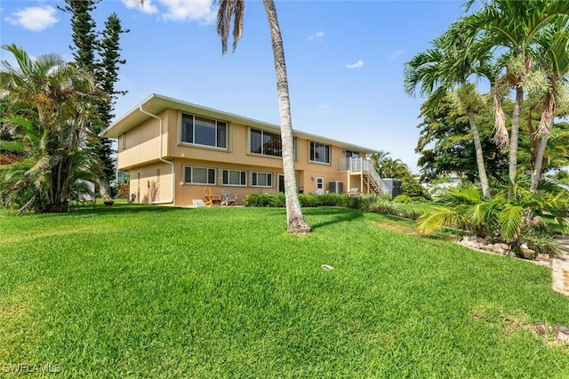 24398 Treasure Island Blvd, Punta Gorda, FL 33955 - rear view of property with a lawn and stairs