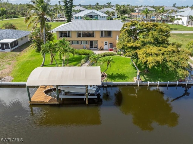 24398 Treasure Island Blvd, Punta Gorda, FL 33955 - dock with a water view, boat lift, a lawn, and a residential view