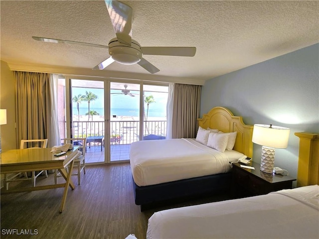 140 Estero Blvd Unit 2206, Fort Myers Beach, FL 33931 - bedroom featuring a textured ceiling, access to exterior, wood finished floors, and a ceiling fan