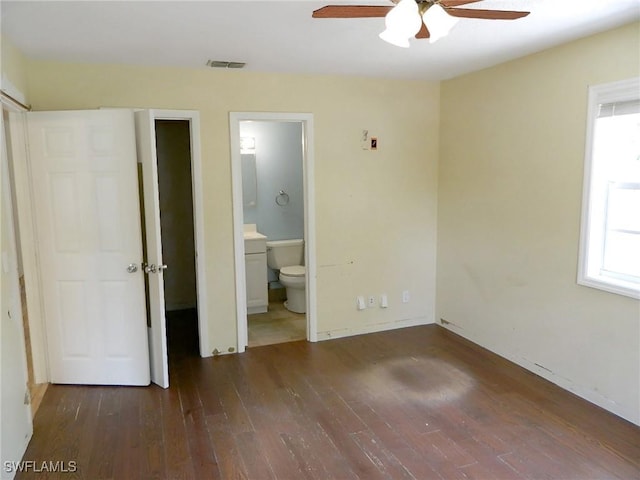 3611 8th Ave SE, Naples, FL 34117 - unfurnished bedroom featuring wood-type flooring, ensuite bath, and ceiling fan