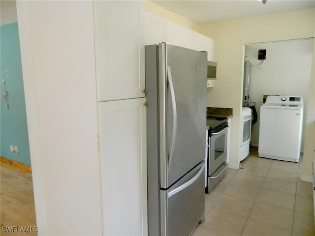 3611 8th Ave SE, Naples, FL 34117 - kitchen featuring appliances with stainless steel finishes, washer / dryer, white cabinetry, and light tile patterned floors