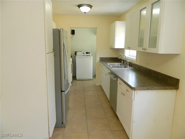 3611 8th Ave SE, Naples, FL 34117 - kitchen featuring dark countertops, washer / dryer, white cabinetry, stainless steel appliances, and light tile patterned floors