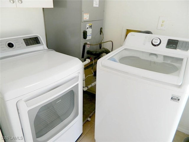 3611 8th Ave SE, Naples, FL 34117 - washroom with washer and clothes dryer, heating unit, and light tile patterned floors