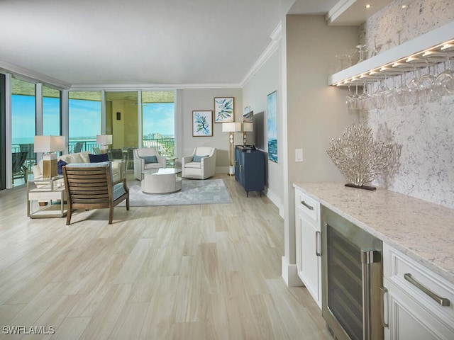 960 Cape Marco Dr Unit 1901, Marco Island, FL 34145 - living area with wine cooler, a dry bar, light wood finished floors, and ornamental molding