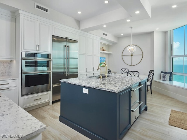 960 Cape Marco Dr Unit 1901, Marco Island, FL 34145 - kitchen featuring stainless steel appliances, white cabinets, recessed lighting, light wood-type flooring, and light stone counters