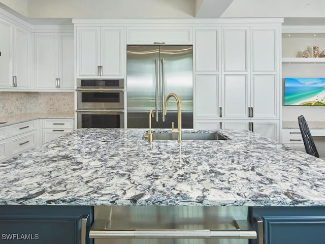 960 Cape Marco Dr Unit 1901, Marco Island, FL 34145 - kitchen featuring appliances with stainless steel finishes, light stone counters, and white cabinetry