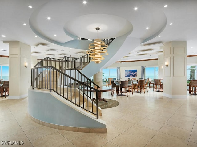960 Cape Marco Dr Unit 1901, Marco Island, FL 34145 - stairway featuring a tray ceiling, tile patterned flooring, a chandelier, and recessed lighting