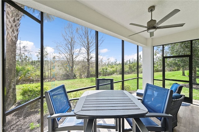 19671 Marino Lake Cir Unit 1602, Miromar Lakes, FL 33913 - sunroom with a ceiling fan, outdoor dining space, and view of wooded area