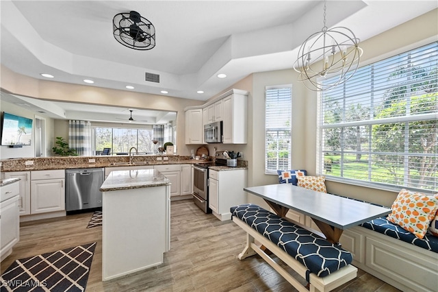 19671 Marino Lake Cir Unit 1602, Miromar Lakes, FL 33913 - kitchen featuring a chandelier, stainless steel appliances, a center island, white cabinets, and recessed lighting