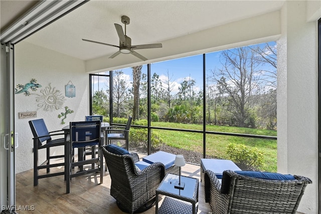 19671 Marino Lake Cir Unit 1602, Miromar Lakes, FL 33913 - sunroom / solarium featuring ceiling fan, outdoor dining area, and view of wooded area