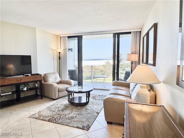 58 N Collier Blvd Unit 404, Marco Island, FL 34145 - living area with a water view, floor to ceiling windows, and light tile patterned floors