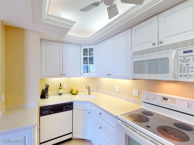 58 N Collier Blvd Unit 404, Marco Island, FL 34145 - kitchen with white appliances, white cabinets, ceiling fan, and light countertops