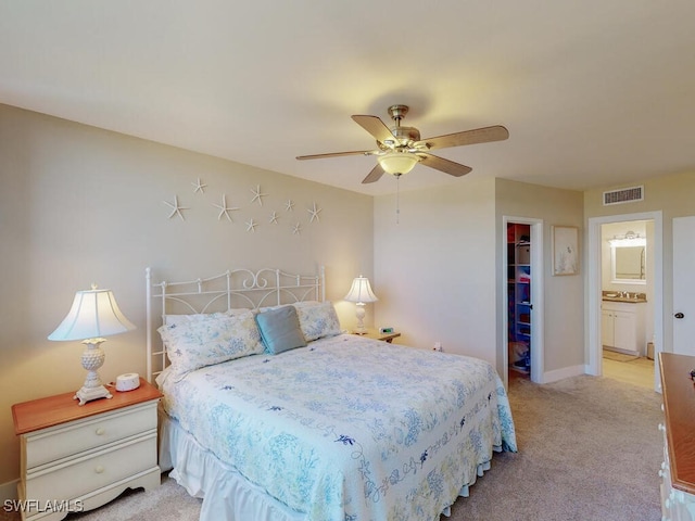 58 N Collier Blvd Unit 404, Marco Island, FL 34145 - bedroom featuring a spacious closet, light carpet, a ceiling fan, and ensuite bath