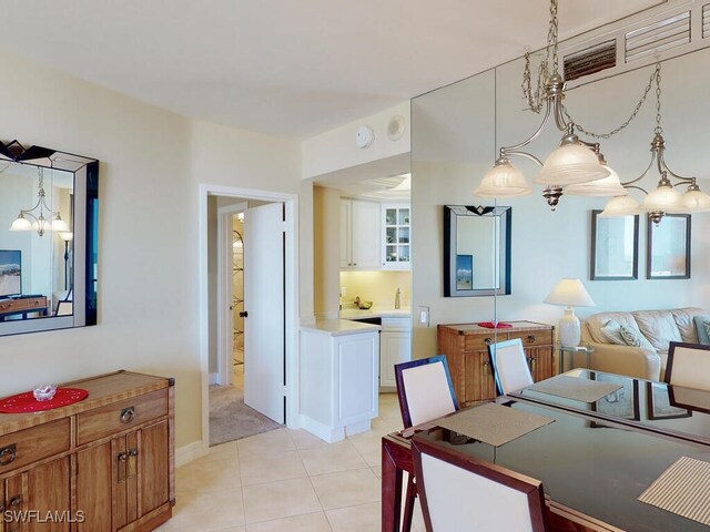 58 N Collier Blvd Unit 404, Marco Island, FL 34145 - dining space featuring light tile patterned floors and a chandelier