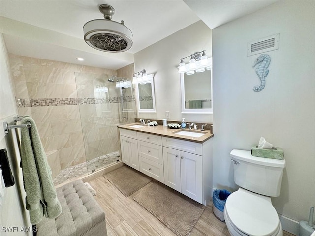 58 N Collier Blvd Unit 404, Marco Island, FL 34145 - bathroom featuring double vanity, walk in shower, and wood finished floors