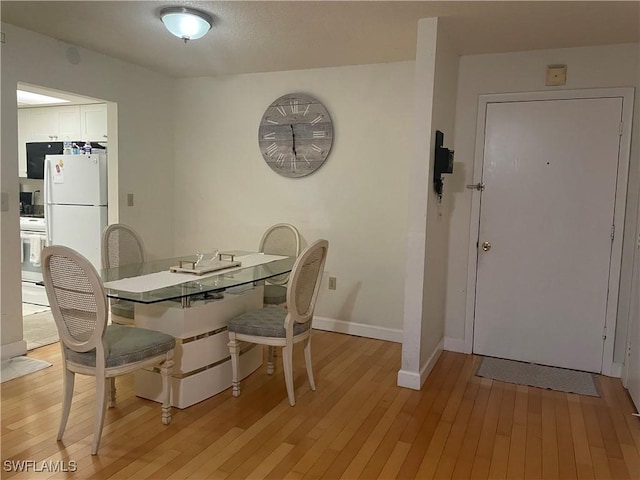 3706 Broadway Unit 27, Fort Myers, FL 33901 - dining room featuring light wood-style floors and baseboards