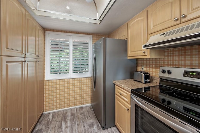 11140 Caravel Cir Unit 306, Fort Myers, FL 33908 - kitchen with stainless steel appliances, light brown cabinets, light wood-type flooring, under cabinet range hood, and light countertops
